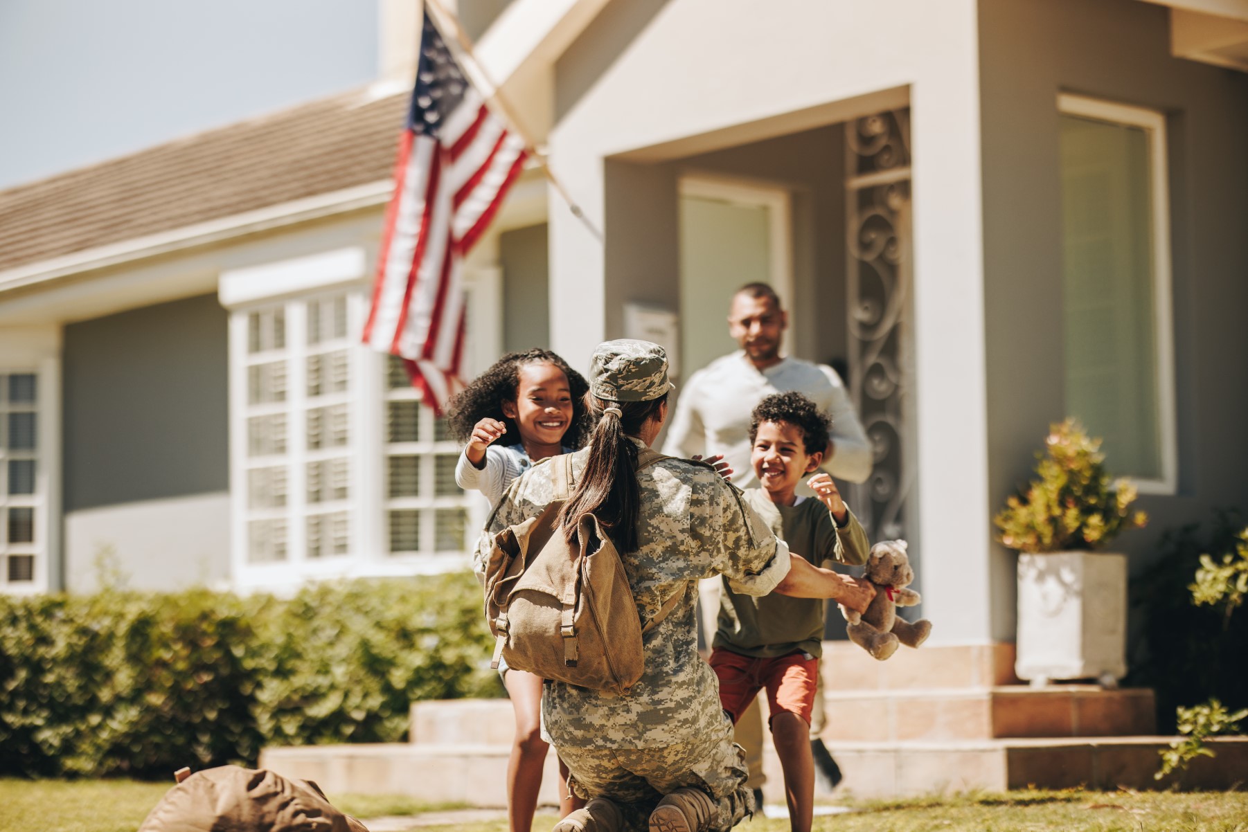 Servicewoman embracing her children